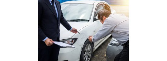 Man with an insurance adjuster examining car damage