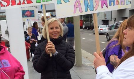 Holly Ennis Holding a Sign Lobbying