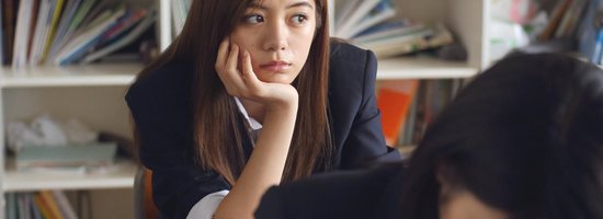 Girl Looking Out Window with Face in Hand