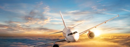 Frequent Flier Miles- airplane in sky with a sunset