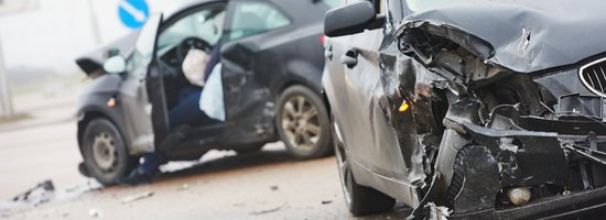 Two damaged vehicles following a car wreck