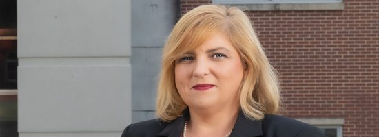 Emily Jolley standing outside Marshall County Courthouse smiling
