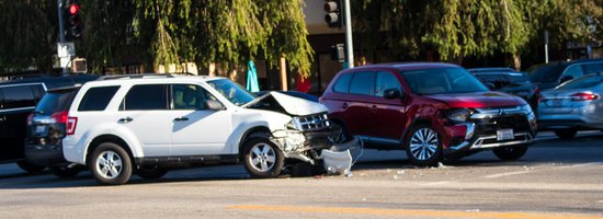 White car with a smashed front end at an accident