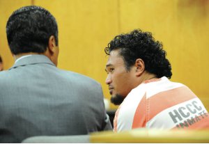 Attorney William Harrison talking to a client in the courtroom